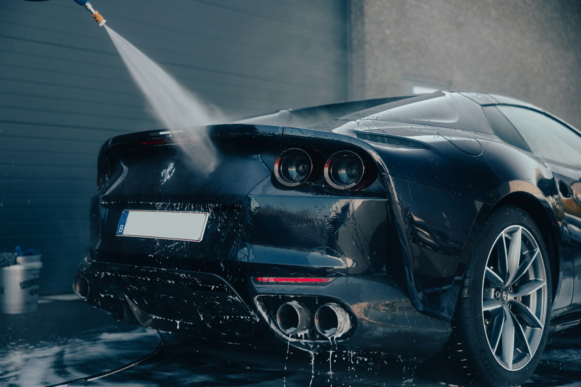 a car being washed with a high pressure washer